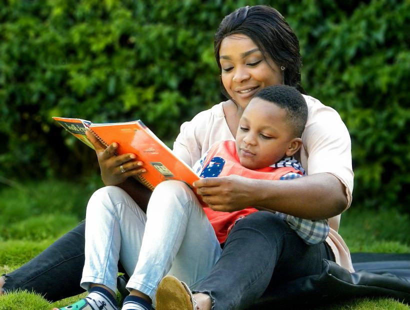 A mother reading a picture book with her young son